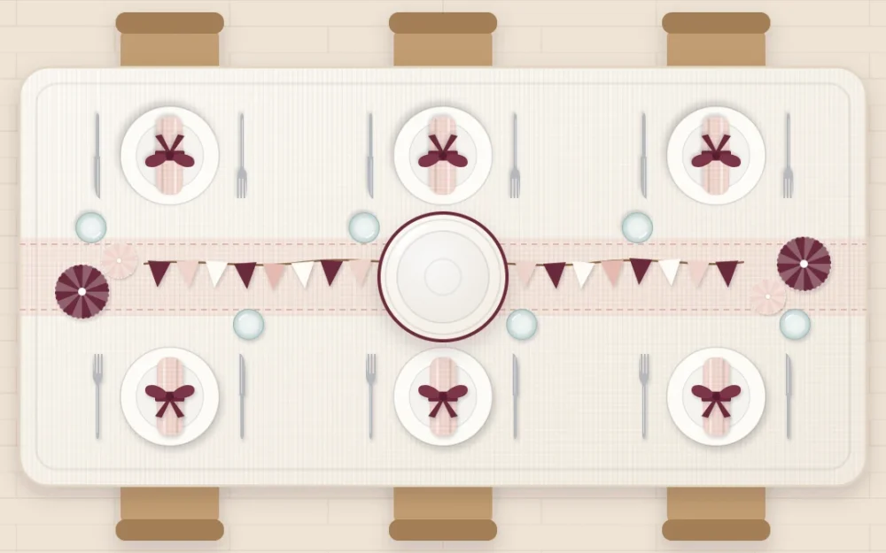 Top-down birthday table in blush and wine with a paper triangle garland along the center, an empty cake stand, ribbon-tied napkins and paper fans