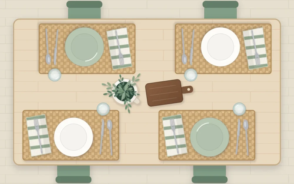 Casual table for four from above with ivory and sage plates on woven placemats, striped napkins and a small jug of herbs